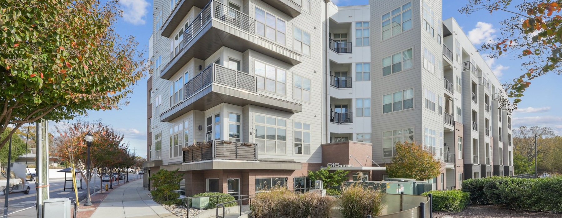 a building with a walkway and trees